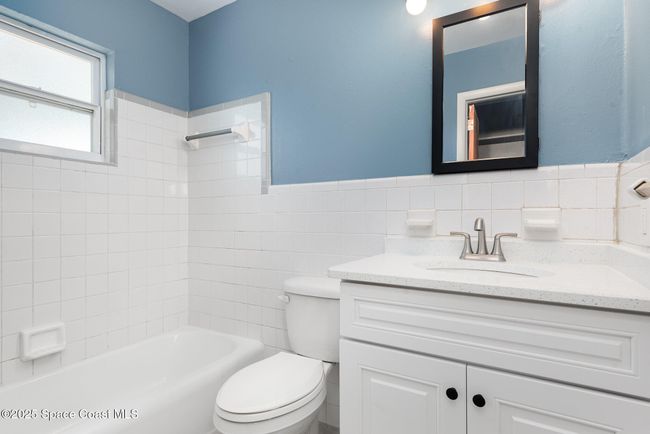 Bathroom offers tub and shower combo, new vanity, light fixture and medicine cabinet | Image 12