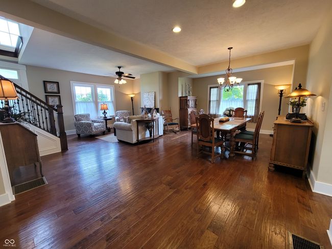 Stunning great room with gleaming hardwood floors and trim. | Image 12