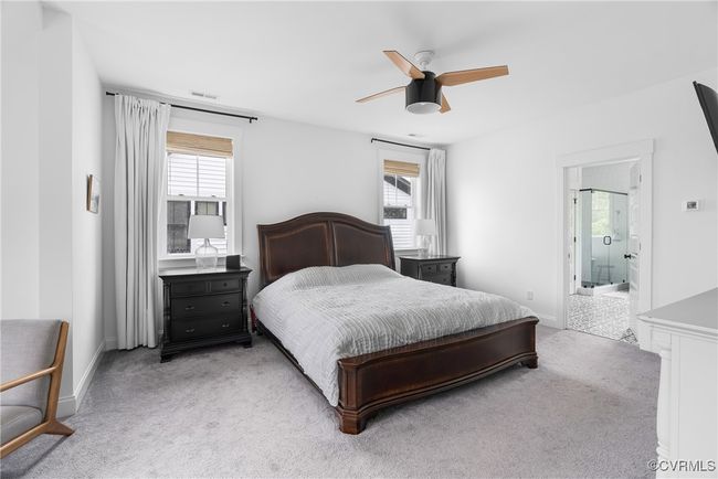 Bedroom featuring light colored carpet, multiple windows, and baseboards | Image 33