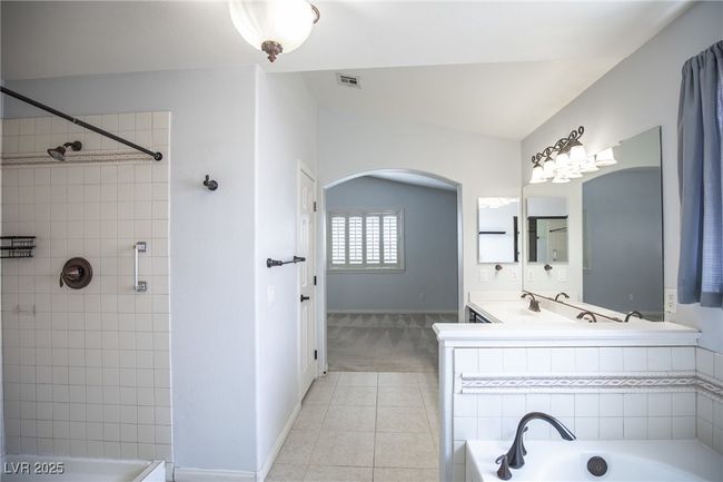 Bathroom featuring a washtub, a tile shower, visible vents, baseboards, and tile patterned flooring | Image 22