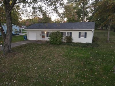 Single story home with a garage and a front yard | Image 1