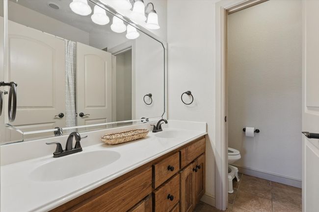 Bathroom with double vanity and tile patterned floors | Image 25