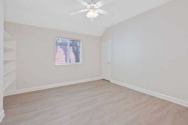 Unfurnished room featuring baseboards, ceiling fan, vaulted ceiling, and light wood finished floors | Image 27