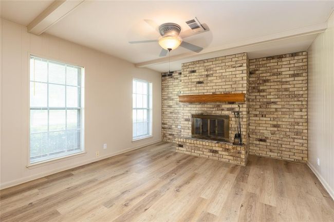 Wood Burning fireplace with recent Wood Laminate flooring | Image 9