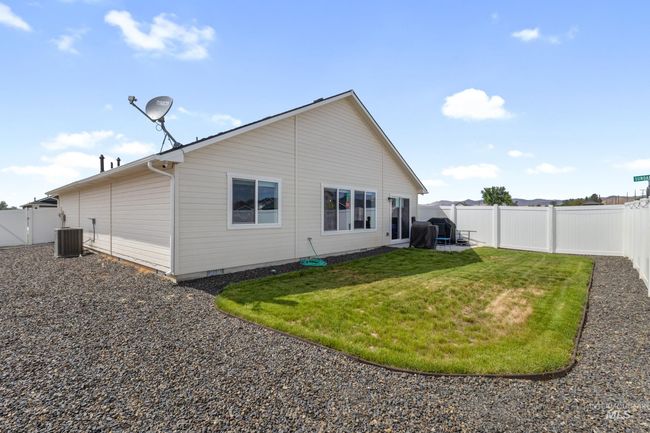 Rear view of house with a fenced backyard | Image 23
