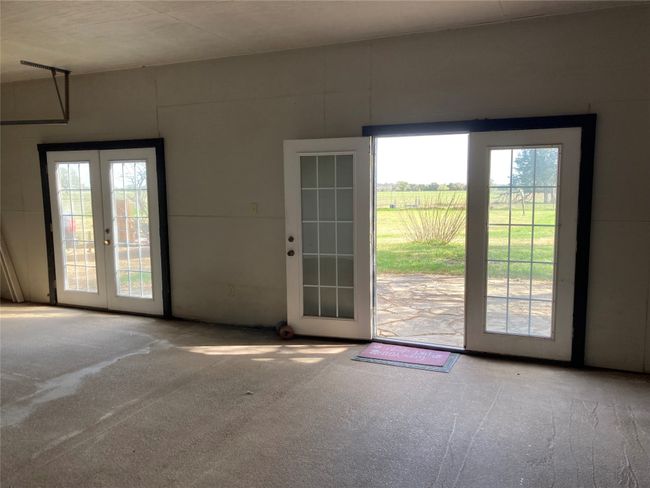 Doorway featuring a rural view, french doors, carpet, and plenty of natural light | Image 11