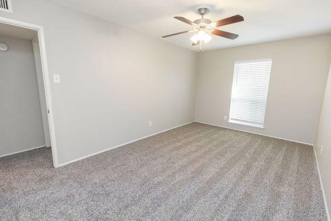 Spare room featuring baseboards, visible vents, ceiling fan, and carpet | Image 30