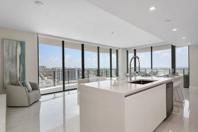 Floor to ceiling windows with panoramic views of ocean & night city skyline | Image 1