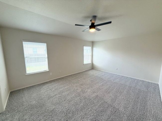 Spare room featuring carpet floors and a ceiling fan | Image 8