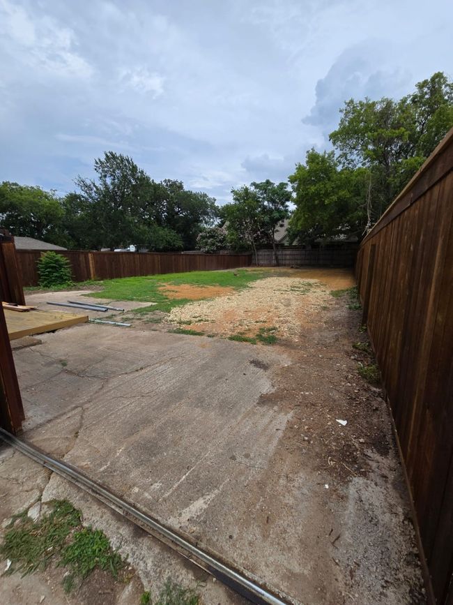 Fenced backyard with a patio | Image 11