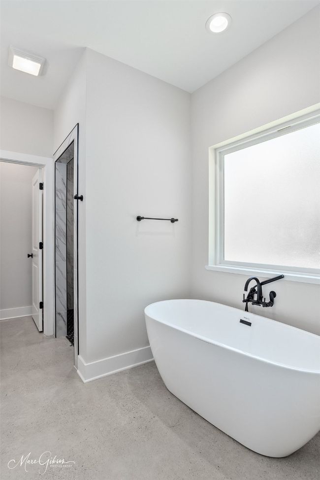 Full bathroom featuring a soaking tub and baseboards | Image 11