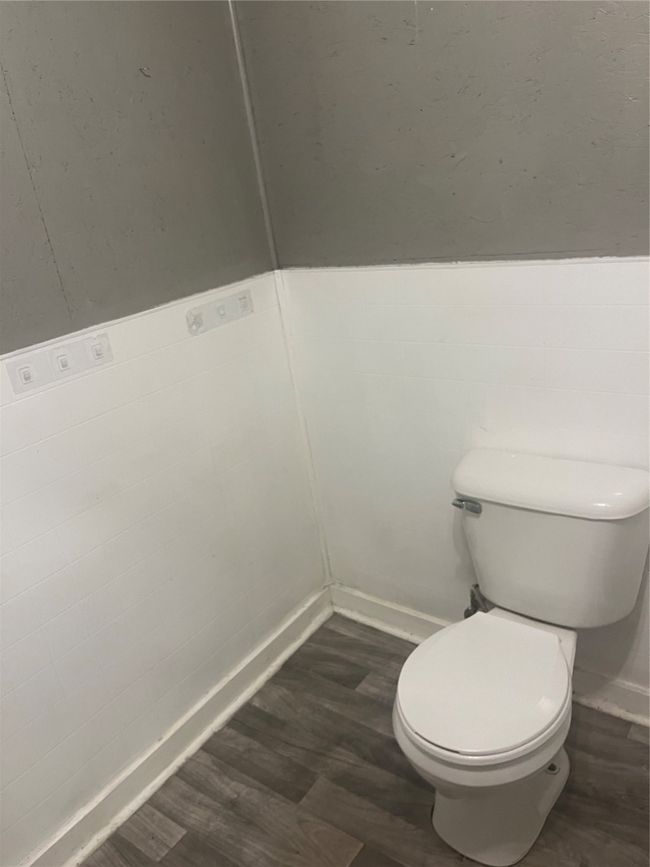 Bathroom featuring toilet and wood finished floors | Image 18