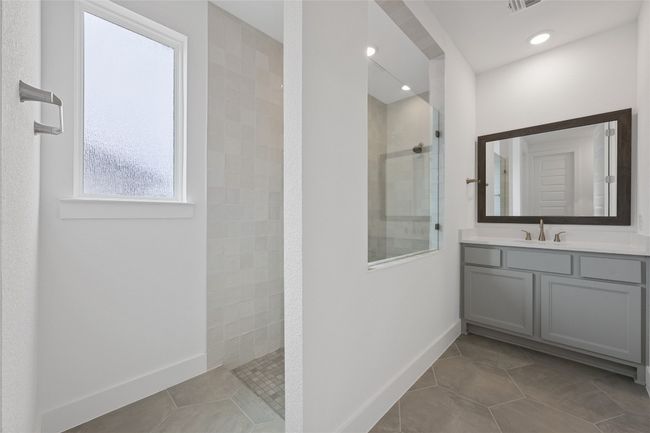 Full bathroom with walk in shower, tile patterned flooring, vanity, baseboards, and recessed lighting | Image 15