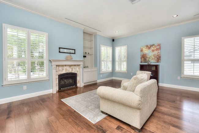 Living room has lots of light, beautiful gas fireplace with backup for starter, plenty of room for a big screen TV and built in shelves. | Image 12