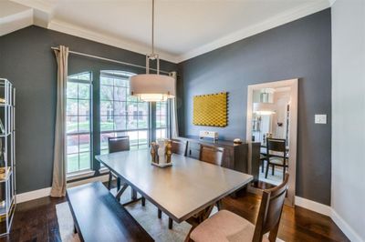 Dining space with crown molding, a wealth of natural light, and dark hardwood / wood-style floors | Image 3