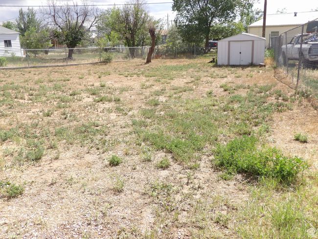 View of yard featuring a storage shed. | Image 42
