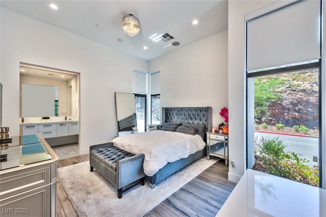 Bedroom featuring visible vents, recessed lighting, wood finished floors, and multiple windows | Image 7
