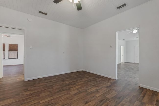 Spare room featuring dark hardwood / wood-style floors and ceiling fan | Image 17