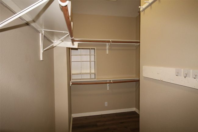Walk in closet with wood finished floors | Image 16