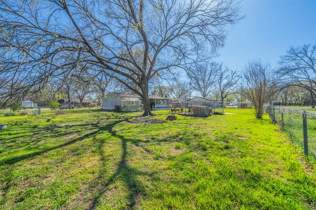 View of yard featuring an outbuilding and fence | Image 17