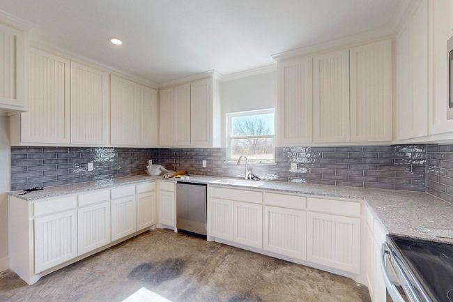 Kitchen featuring crown molding, decorative backsplash, a sink, and stainless steel appliances | Image 16