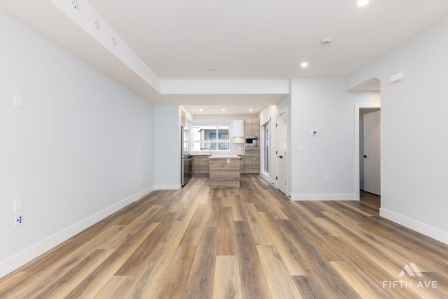 Unfurnished living room featuring light wood-style floors and recessed lighting | Image 12