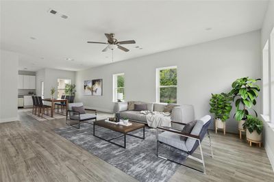 Living room featuring ceiling fan and light hardwood / wood-style floors | Image 1