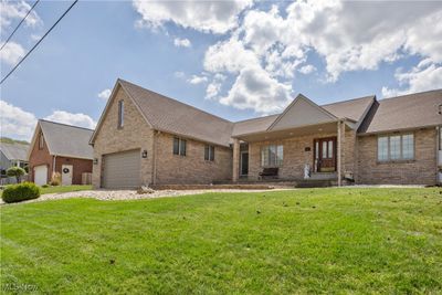 View of front of home with a garage and a front yard | Image 2