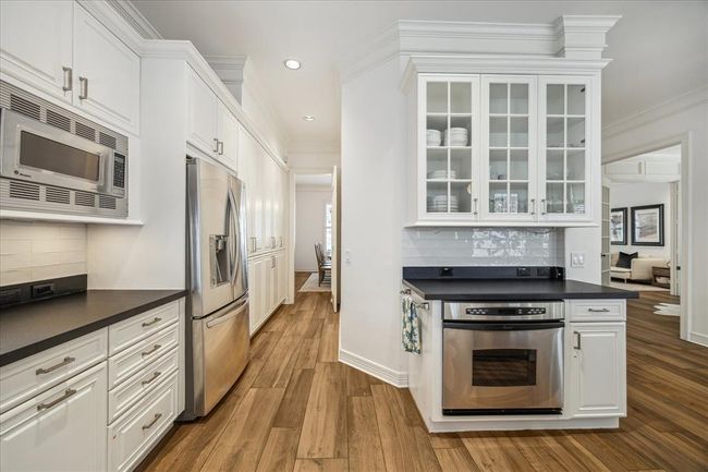 Looking back to the dining room from the kitchen. European pantry on the right. Glass cabinets for displaying your fine china or glassware. In ceiling speakers in this kitchen are an added bonus! | Image 10