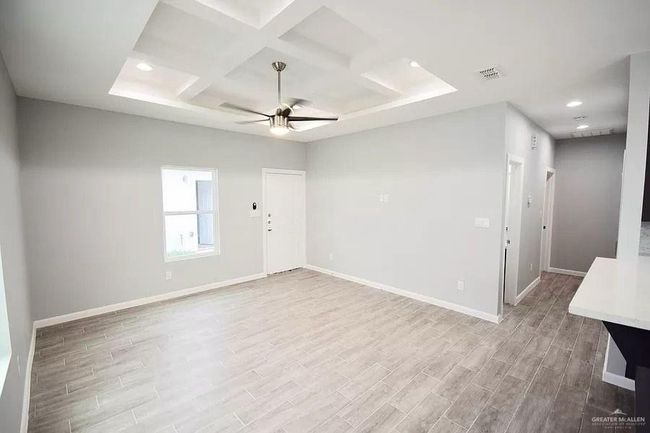 Spare room with baseboards, wood finished floors, and visible vents | Image 5
