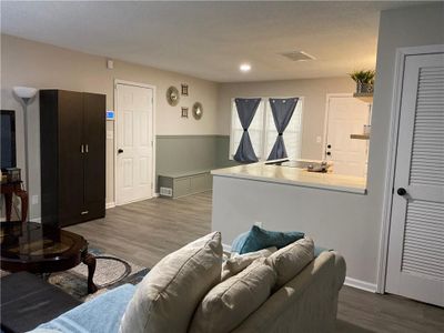 Living room with a textured ceiling and accent wall | Image 3