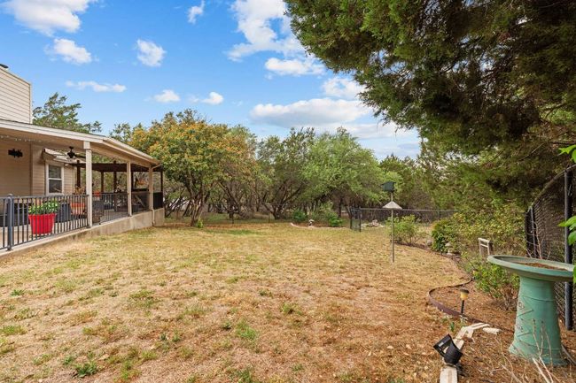 View of yard with fence, a ceiling fan, and a patio | Image 26