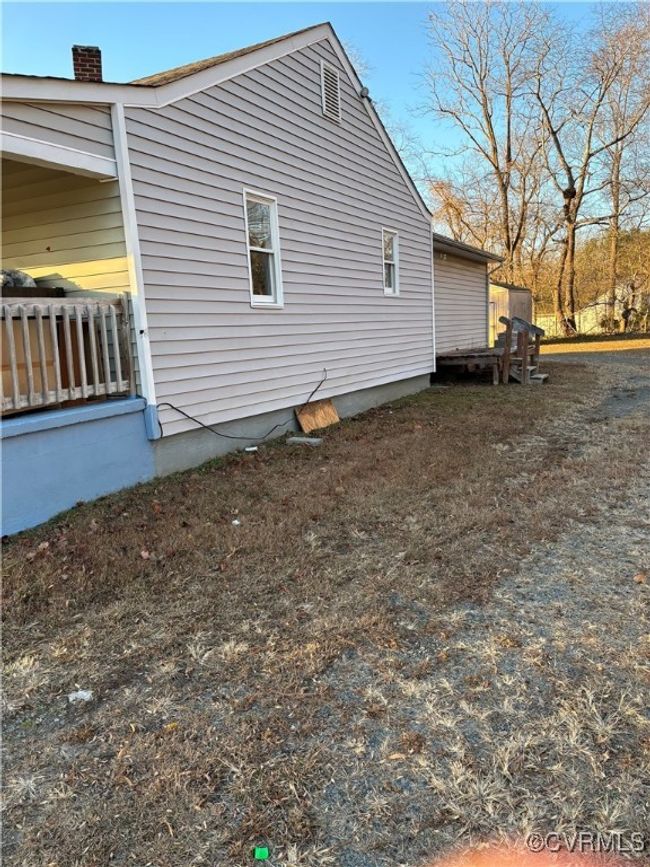 View of home's exterior featuring a chimney | Image 4
