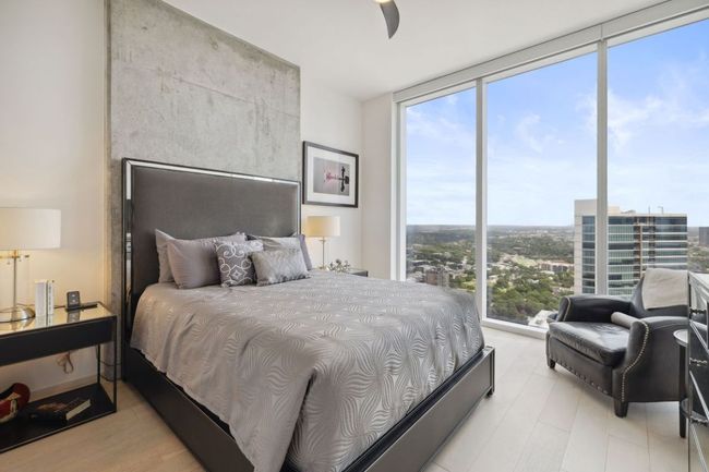 Bedroom with floor to ceiling windows, multiple windows, wood finished floors, and ceiling fan | Image 20