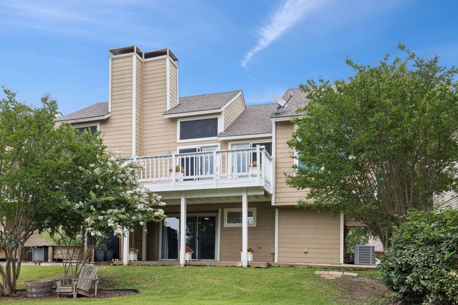 Back of house with central air condition unit, a yard, roof with shingles, a wooden deck, and a chimney | Image 25