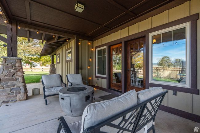 View of patio with an outdoor living space with a fire pit | Image 7