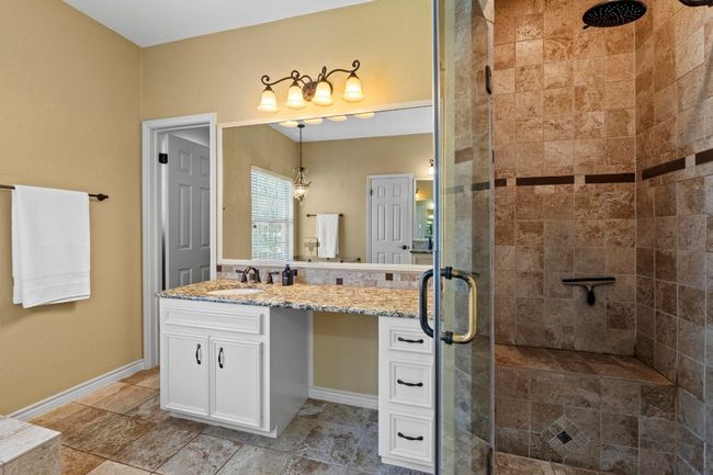 Bathroom featuring a shower stall, vanity, and baseboards | Image 23