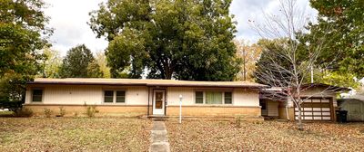 View of front facade with a storage unit and a garage | Image 1