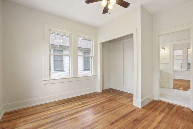 Unfurnished bedroom with light wood-style floors, a closet, and ceiling fan | Image 15