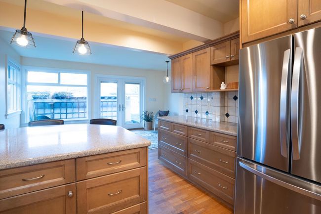 Kitchen featuring tasteful backsplash, french doors, freestanding refrigerator, open shelves, and pendant lighting | Image 10