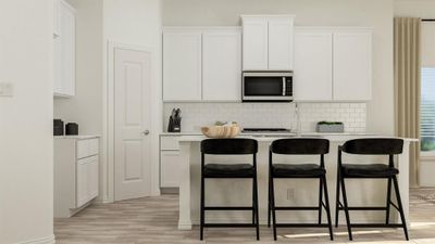 Kitchen featuring decorative backsplash, a breakfast bar, white cabinetry, and light hardwood / wood-style flooring | Image 2