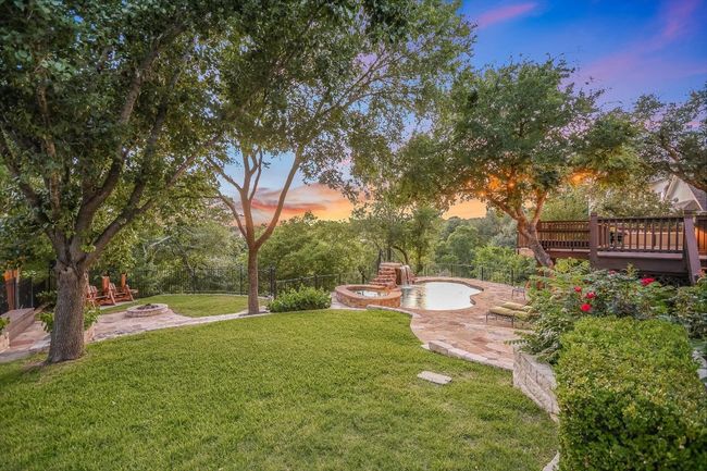 View of yard featuring a fire pit, a patio, and a wooden deck | Image 36