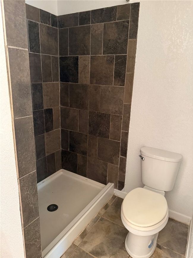 Bathroom with baseboards and a stall shower | Image 11