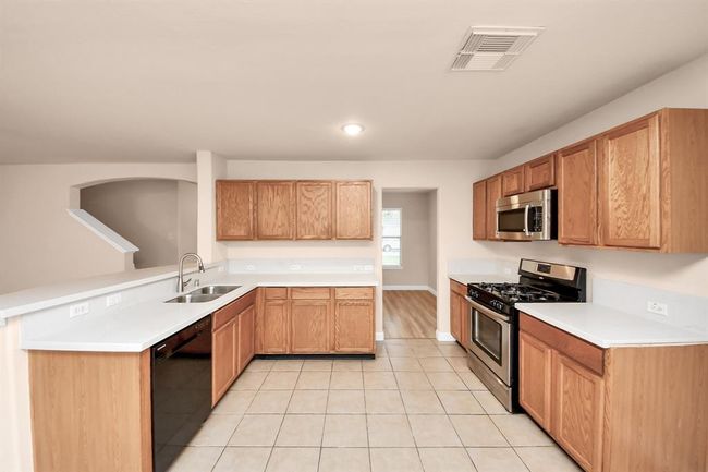 Open kitchen with new granite countertops and new sink. | Image 9