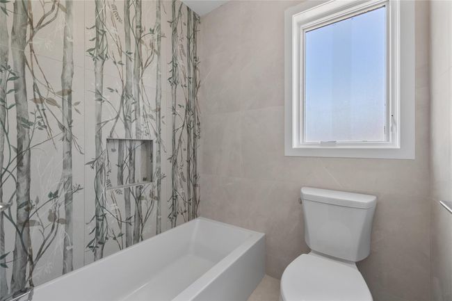 Bathroom with toilet and tile walls | Image 35