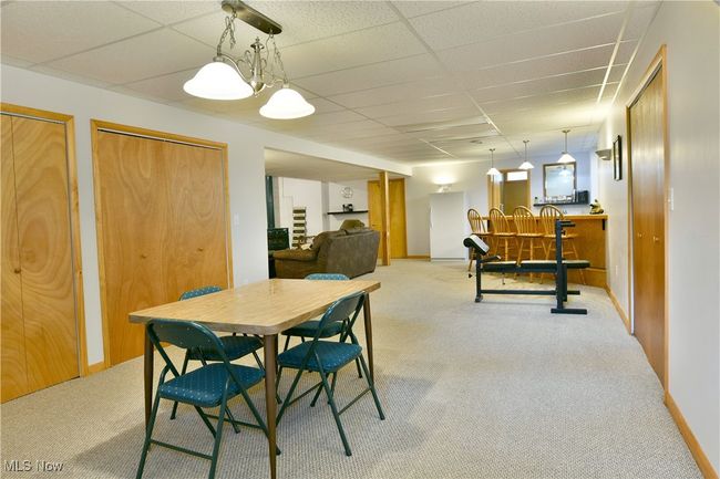 Dining room featuring carpet floors and a paneled ceiling | Image 35