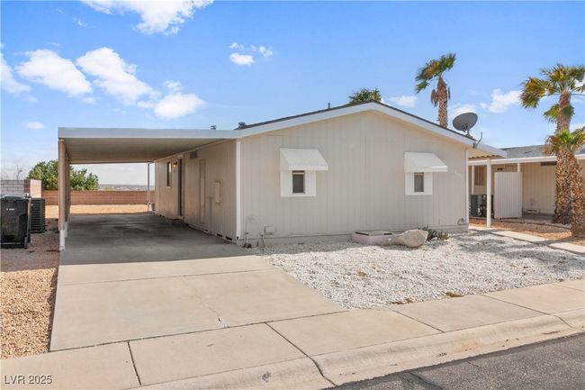 View of side of property with central AC unit, an attached carport, and concrete driveway | Image 29