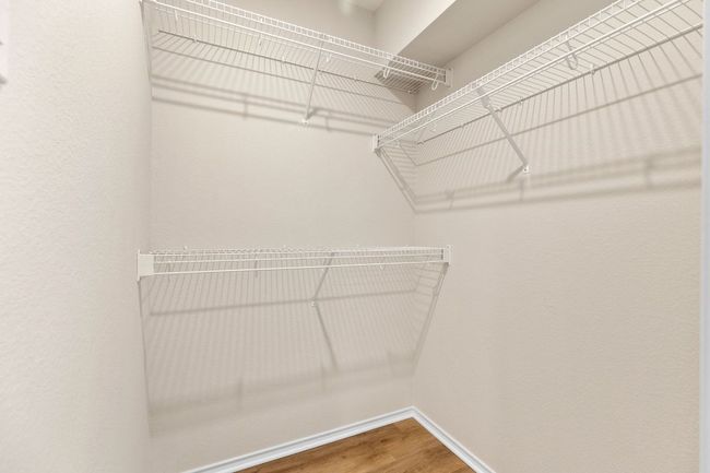 Walk in closet featuring wood finished floors | Image 27