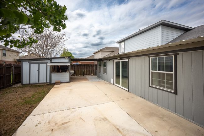 View of patio featuring an outdoor structure, a fenced backyard, and a shed | Image 16