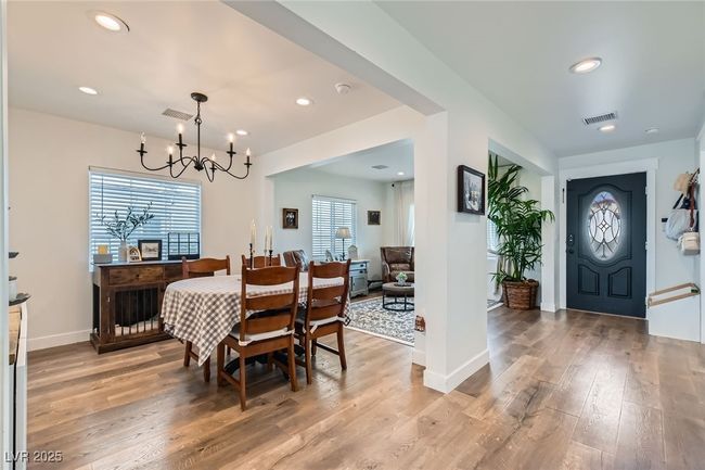 Dining area featuring a chandelier, light wood finished floors, recessed lighting, and baseboards | Image 8